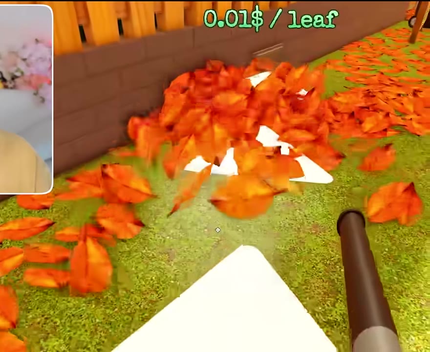 Leaf blower moving a dense pile toward a collection area